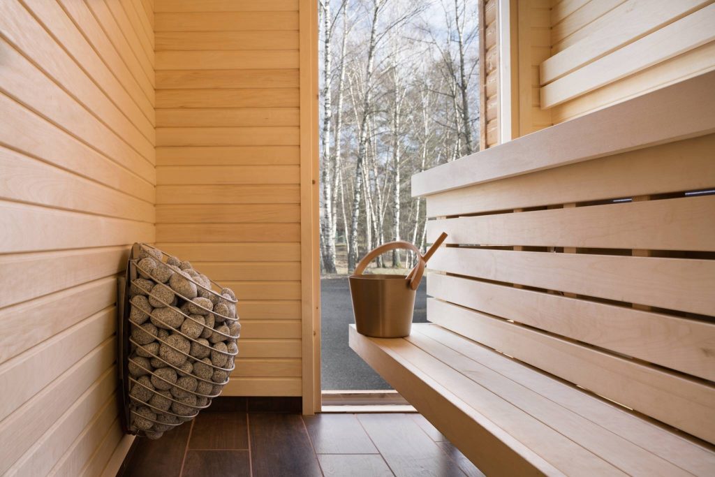 What are the benefits of using a wood sauna stove?